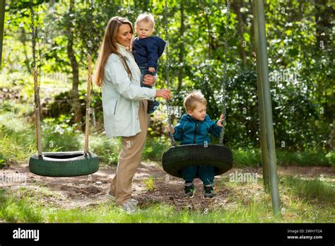 The Mother With Two Children Is Having A Fun Time At The Playground