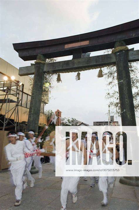 Rice Bales Being Carried Through A Torii Gate At Hadaka Matsuri Naked