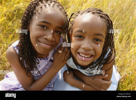 Two girls sit together Stock Photo - Alamy