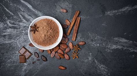 Top View Of Cocoa Powder In White Bowl And Whole Beans With Spices