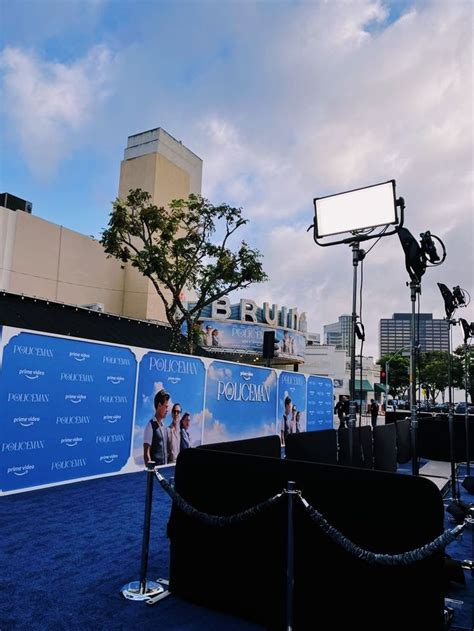 A Blue Carpeted Area With An Outdoor Movie Set And Billboards In The