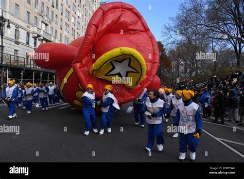 Handlers Struggle To Keep Harold The Fireman Giant Balloon Low Because Of High Wind During The