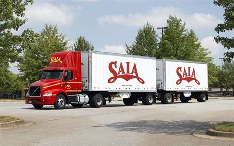 SAIA Truck - Red and White Semi Truck in Parking Lot