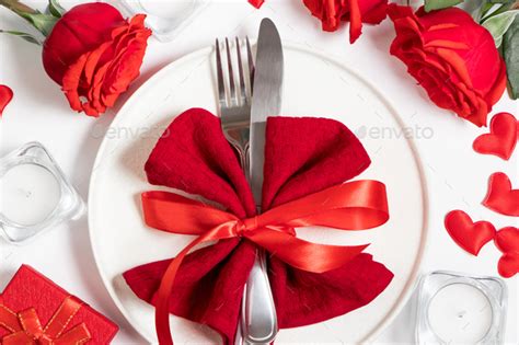 Table Setting For Valentines Day Red Roses And Cutlery On A White