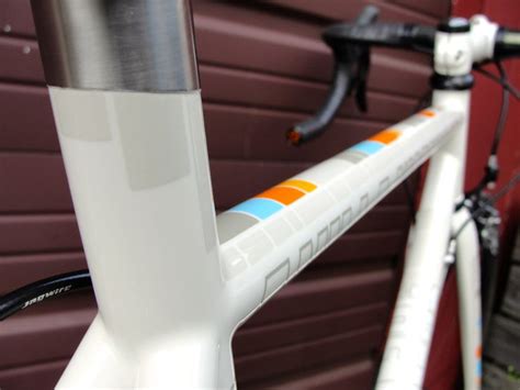 The Front End Of A Bicycle Parked Next To A Garage Door