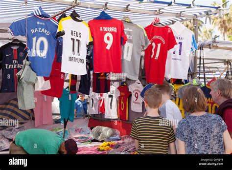 A Child Looking At Football Shirts At A Market Stall Estepona Market