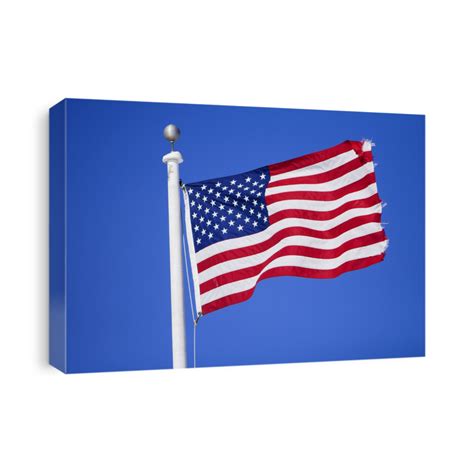 American Flag Flying Over A Blue Background Canvas Print Canvasworld