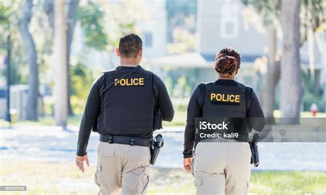 Two Police Officers Walking In Community Stock Photo Download Image