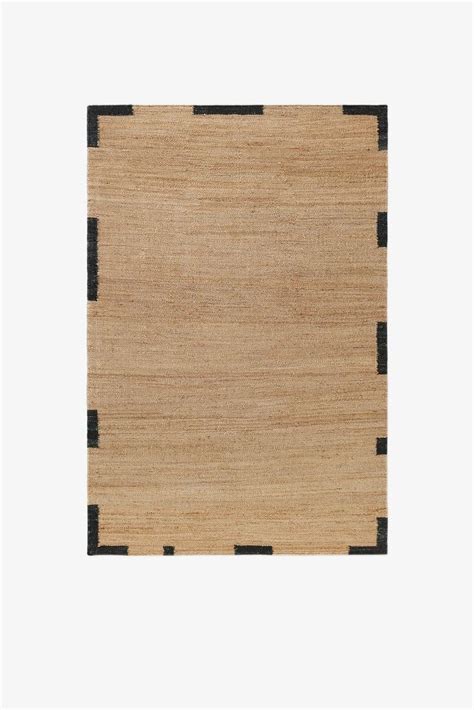 An Area Rug With Black And Beige Stripes