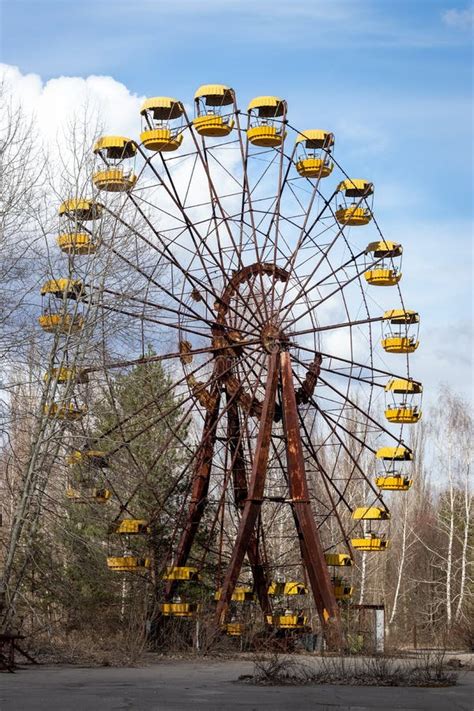 Old Abandoned Rusty Metal Radioactive Yellow Ferris Wheel Against