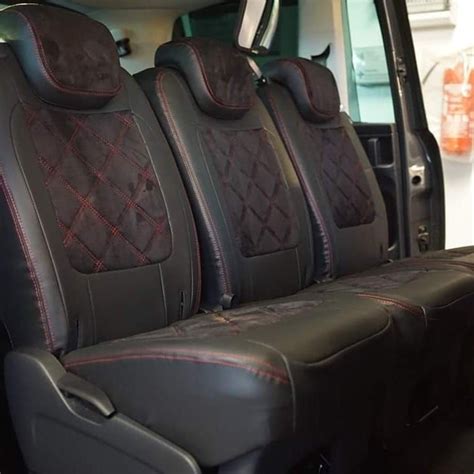 The Interior Of A Vehicle With Black Leather Seats And Red Stitching On