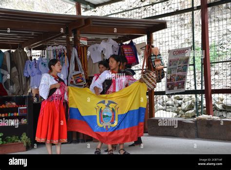 Ecuadorian Native People In Traditional Clothes Holds The National Flag