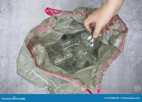 Hand Getting Plastic Bottles To Dispose In Garbage Bag Ready To Recycle