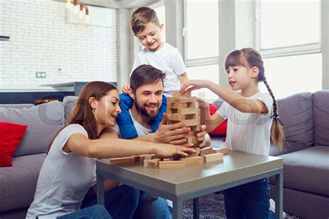 Happy family playing board games at home. | Stock image | Colourbox