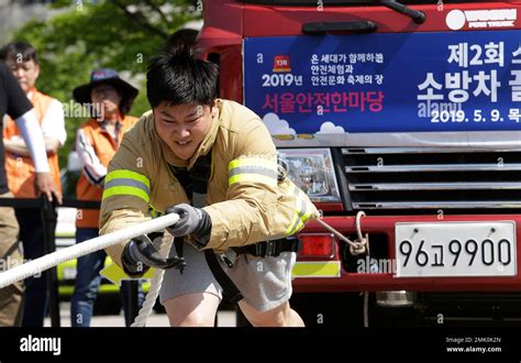 Firefighter Lim Sung Joo Pulls A Fire Truck By A Rope During The Safe