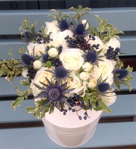 Milk Churn with White Roses and Blue Thistles | Flower Arrangements