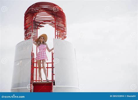 Young Blonde Girl Look Like A Barbie Doll In Pink Mini Dress And Wide Brim Hat Standing On