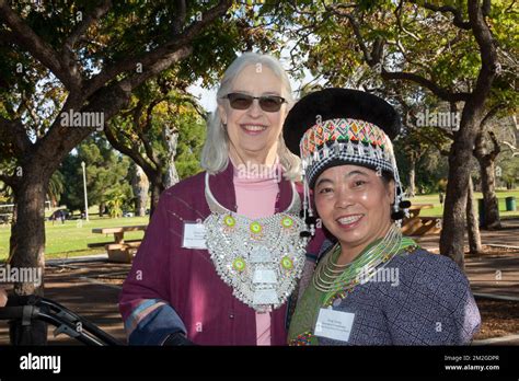 White Female Historian Receives A Silver Necklace From Hmong Female