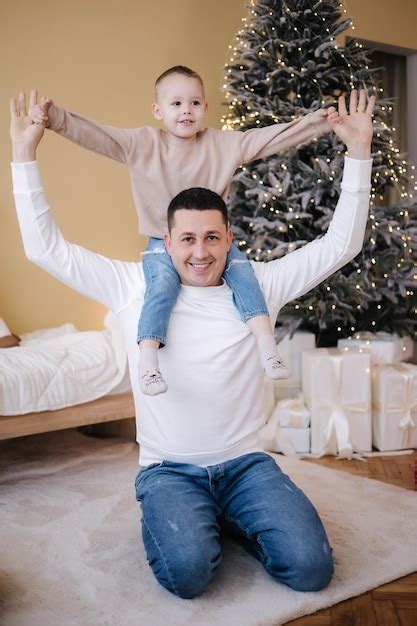 Premium Photo Happy Father With His Son Playing Home During Winter