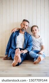 Mature Father Small Son Sitting Indoors Stock Photo