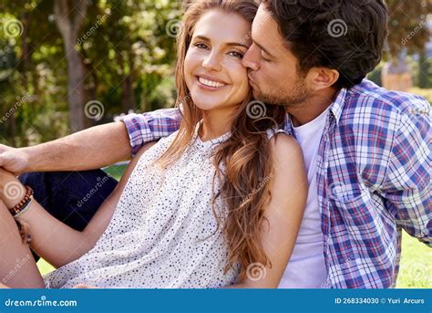 Couple Love And Cheek Kiss On Love Date Nature Grass Or Garden Park On Valentines Day Romance