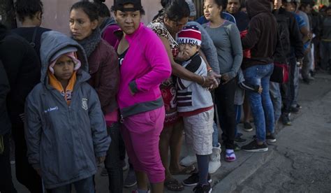 Central American Migrants Wait In Line For A Donated Breakfast At A