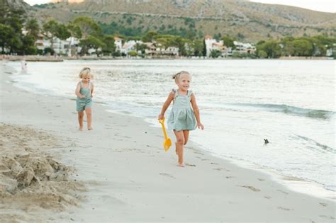 Premium Photo | Barefoot girl and boy in summer clothes strolling on ...