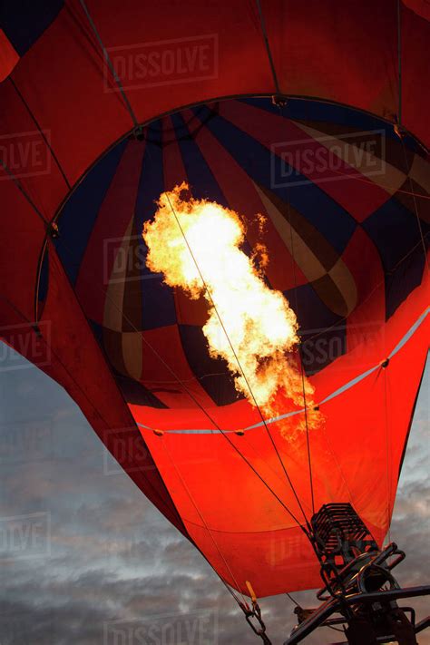 Low Angle View Of Fire In Hot Air Balloon Against Sky Stock Photo Dissolve