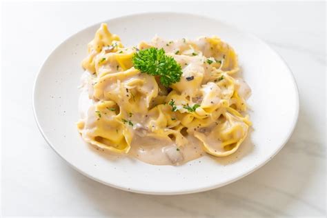 Pasta tortellini con salsa de crema de champiñones y queso estilo de