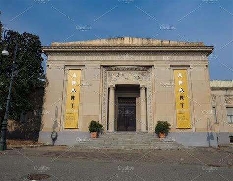 An Old Building With Steps Leading Up To The Front Door And Two Potted