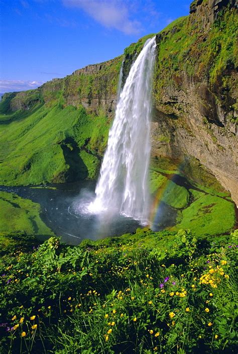 A Large Waterfall With A Rainbow In The Middle Of It S Water Fall