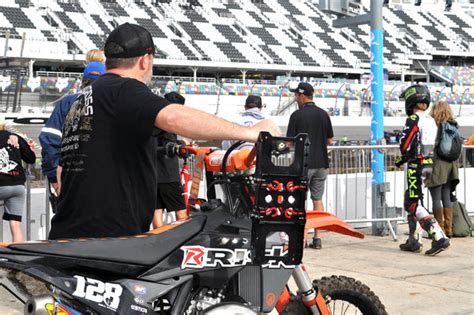 Mx Racer Pushing His Dirt Bike Through The Pits At Daytona With A Pair