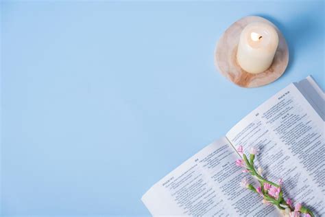 Christian Holy Bible With Candle On Blue Background Top View Flat Lay