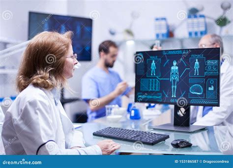 Female Scientist Looking At The Monitor Screen In Research Room Stock