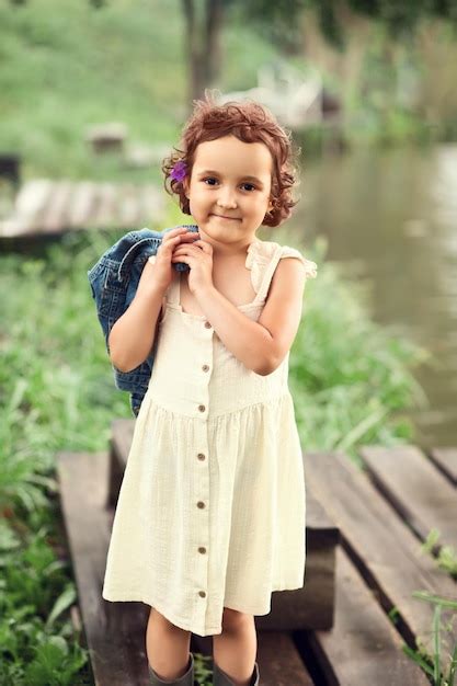 Premium Photo Portrait Of Smiling Girl Standing Outdoors