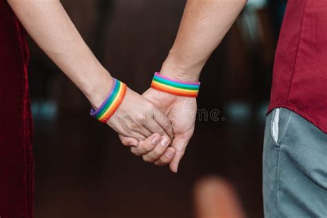 The Lgbt Couple Or Lgbtqia Couple Wear Rainbow Colored Wristbands On