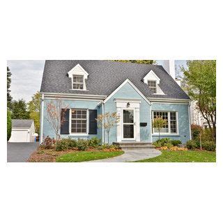 Blue Painted Brick House with White Dormer Windows