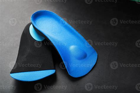 Orthopedic insoles for correction of pronation of the foot on a dark background. 10703772 Stock ...