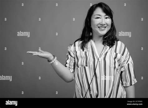 Mature Beautiful Asian Businesswoman Against Gray Background Stock Photo Alamy