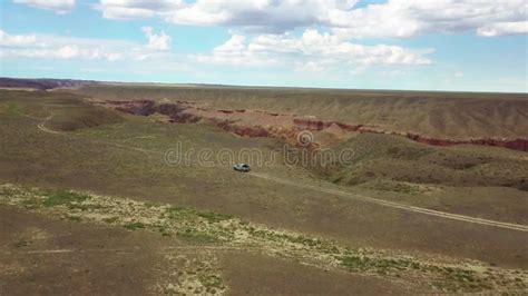 Pickup Truck Traveling Fast On A Dirt Road On The Edge Of A Beautiful