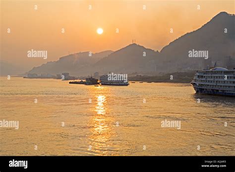 China Yangtze River Cruise Ships Freighters And Barges Docked At Sunset