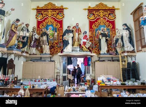 Statues Of Catholic Saints Above A Thrift Shop In Valletta Malta Stock