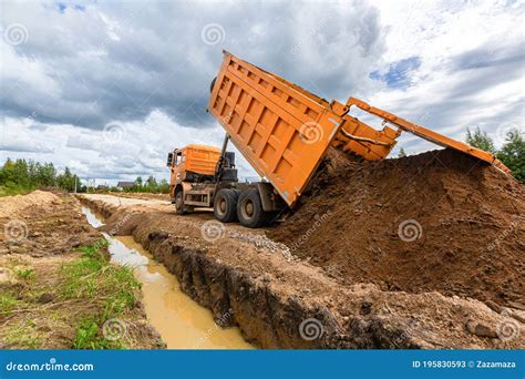 Construction Truck Tipping Or Dumping Sand On Road During Construction