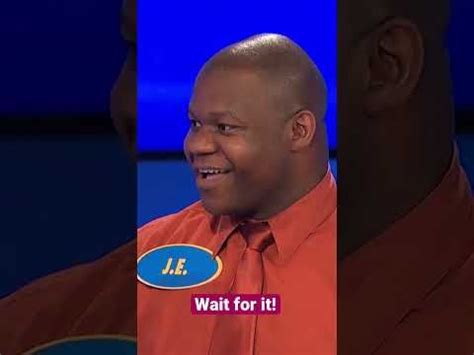 a man in an orange shirt and tie with the words wait for it on his chest