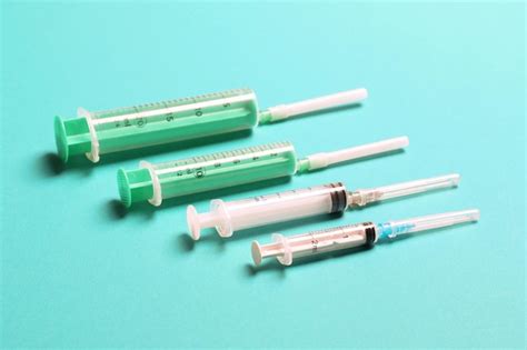 Premium Photo Top View Of Different Syringes For Injection On