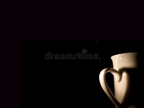 White Coffee Cup With Shadow From Handle In Heart Form Black Background On International Coffee