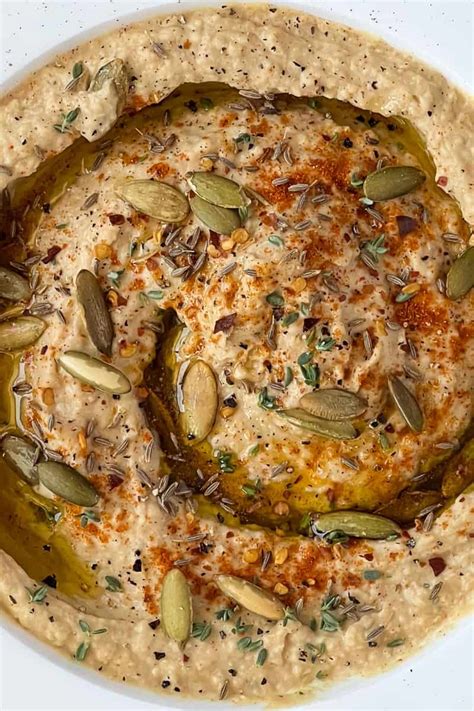 Close Up Of Butter Bean Hummus Garnished With Seasoning Whole Seeds