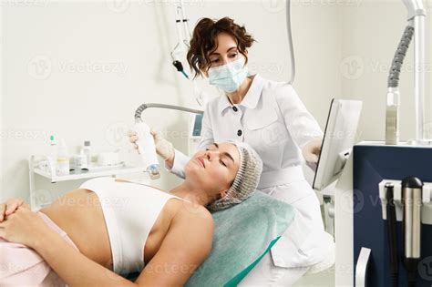 Doctor And Woman Client During Radiofrequency Lifting Treatment In A