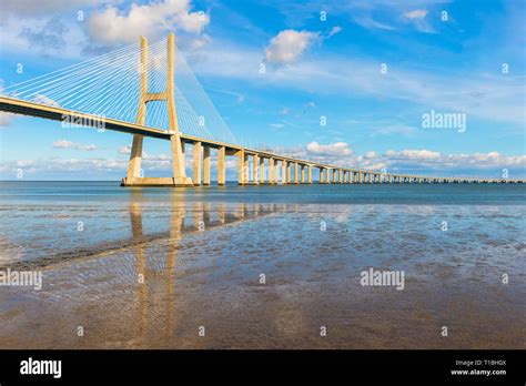 Vasco De Gama Bridge Reflecting In The Tagus River Lisbon Portugal