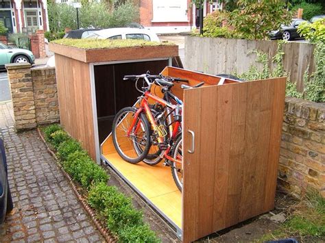 A Bike Is Parked In The Back Of A Wooden Storage Shed With Grass